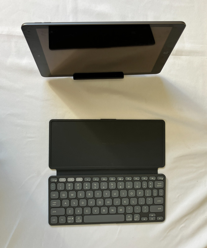 iPad on Ugreen tablet stand with Logitech Keys to Go 2 for typing on the road.