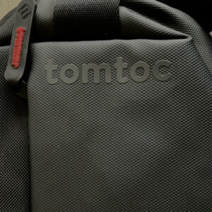 Logo on Tomtoc travel sling